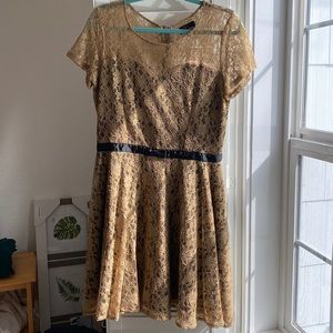 Yumi, gold lace over black shell with black ribbon at waist, size 8-10 US